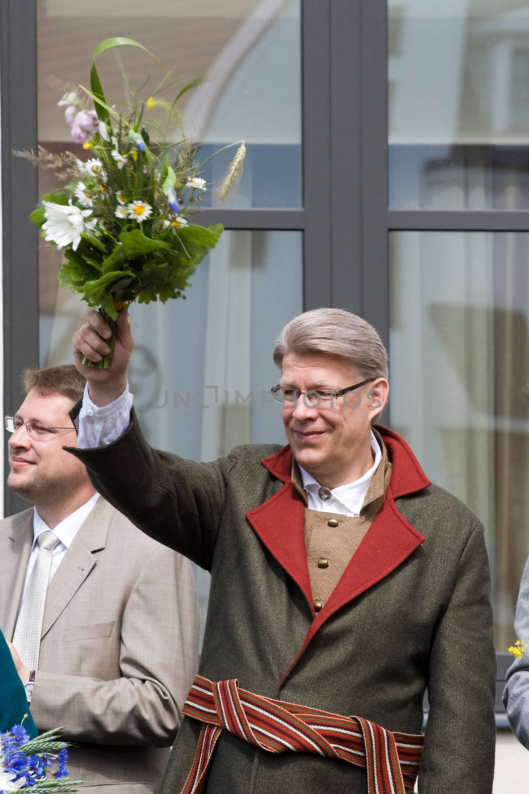 President of Latvia Valdis Zatlers wearing traditional costume greets the participants of the procession of the Song and Dance Celebration festival in Riga, Latvia