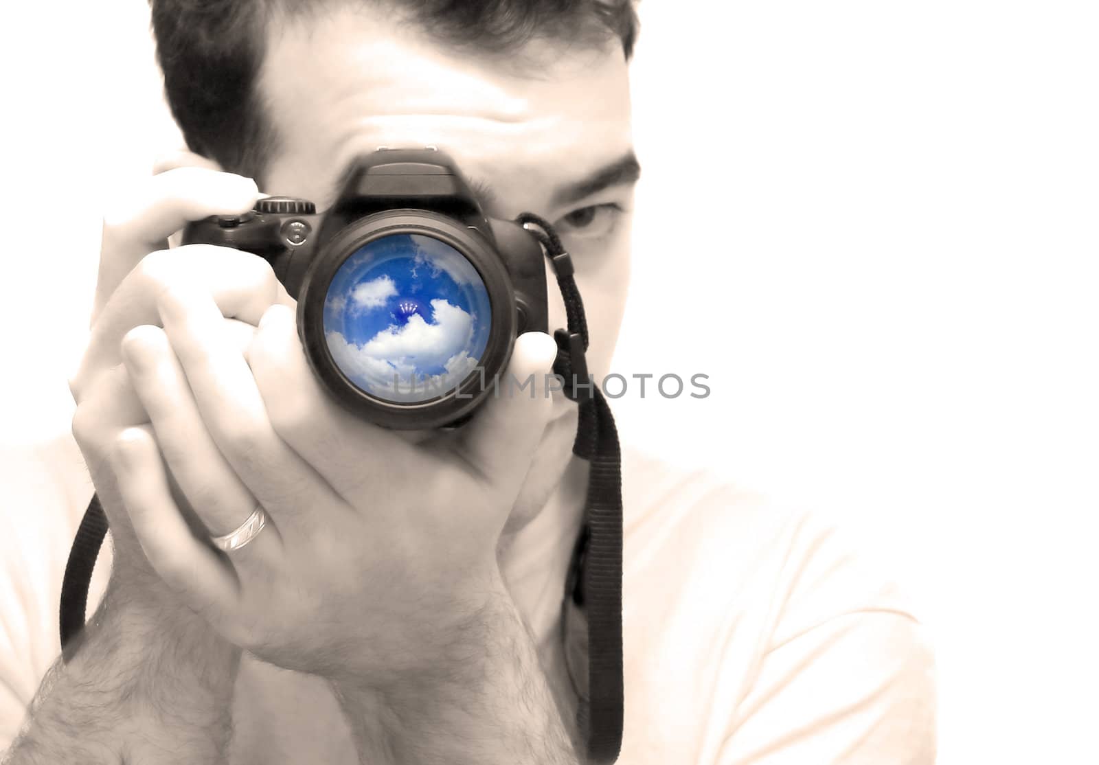 A young photographer taking a shot with his DSLR camera.  Selective color and shallow depth of field.