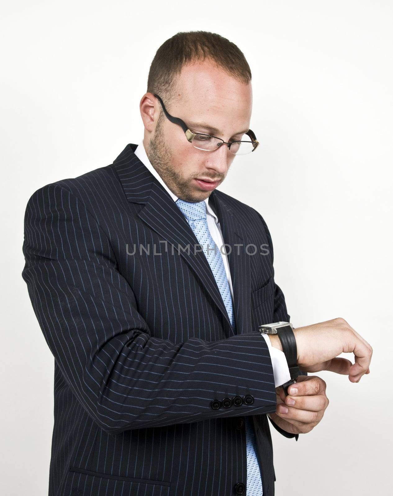 businessman tighting the watch-strap on isolated background

