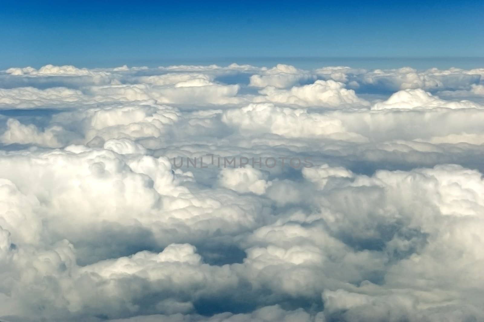 Blue sky with clouds, view from plane somewhere above Yunnan province in China.