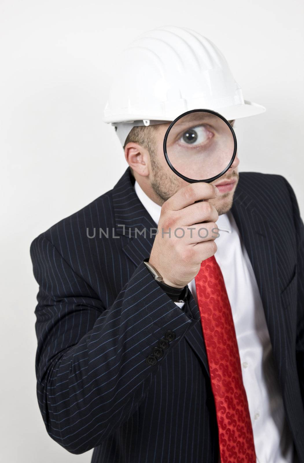 architect with magnifier on isolated background
