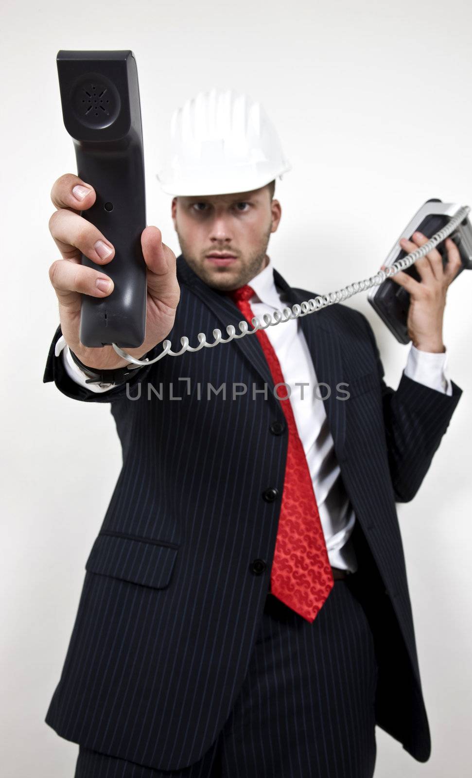 architect holding phone receiver on isolated background

