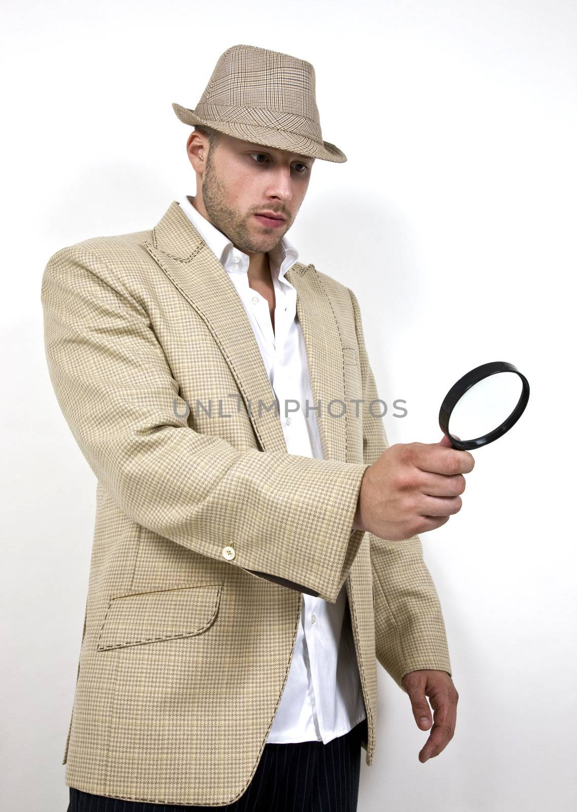man with fedora hat and magnifier on isolated background
