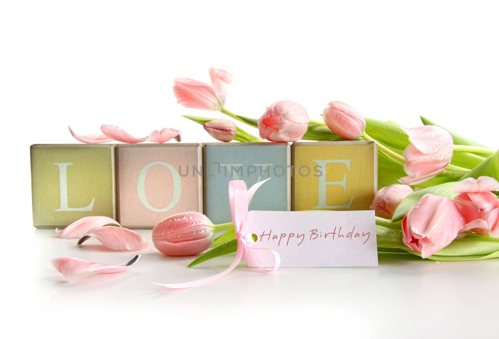 Wooden blocks with tulips and gift card on white