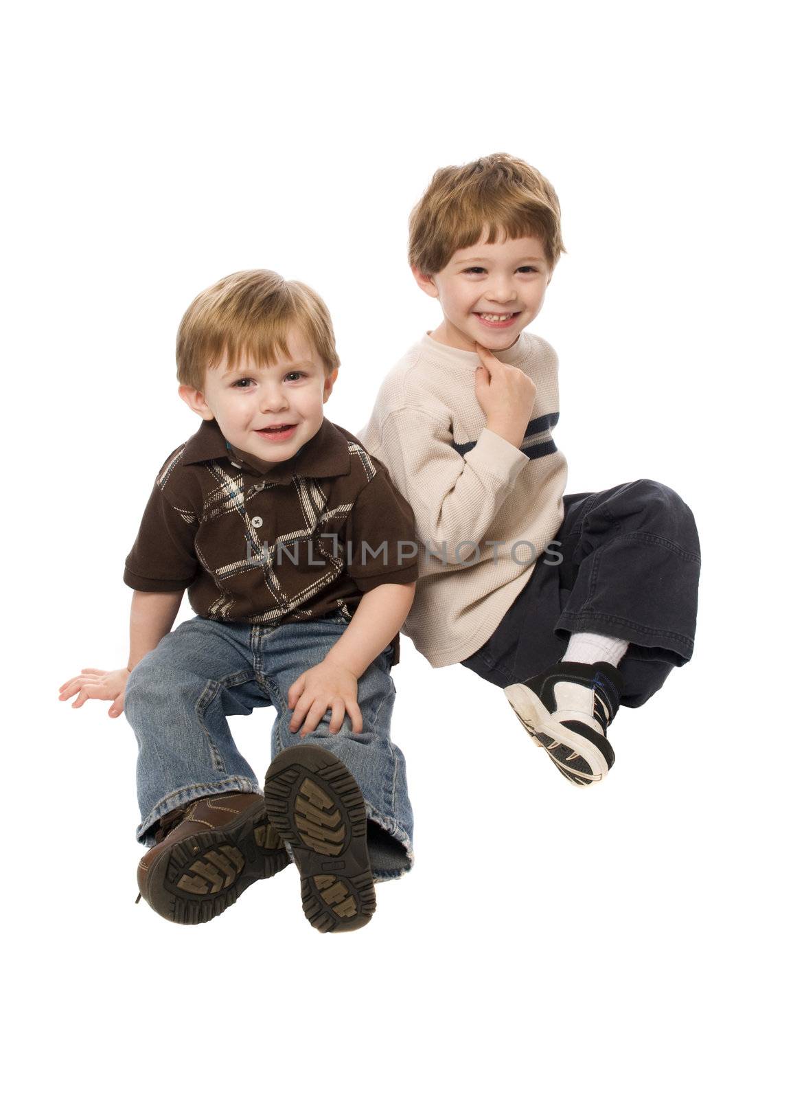 Child having a good time posing on a white background