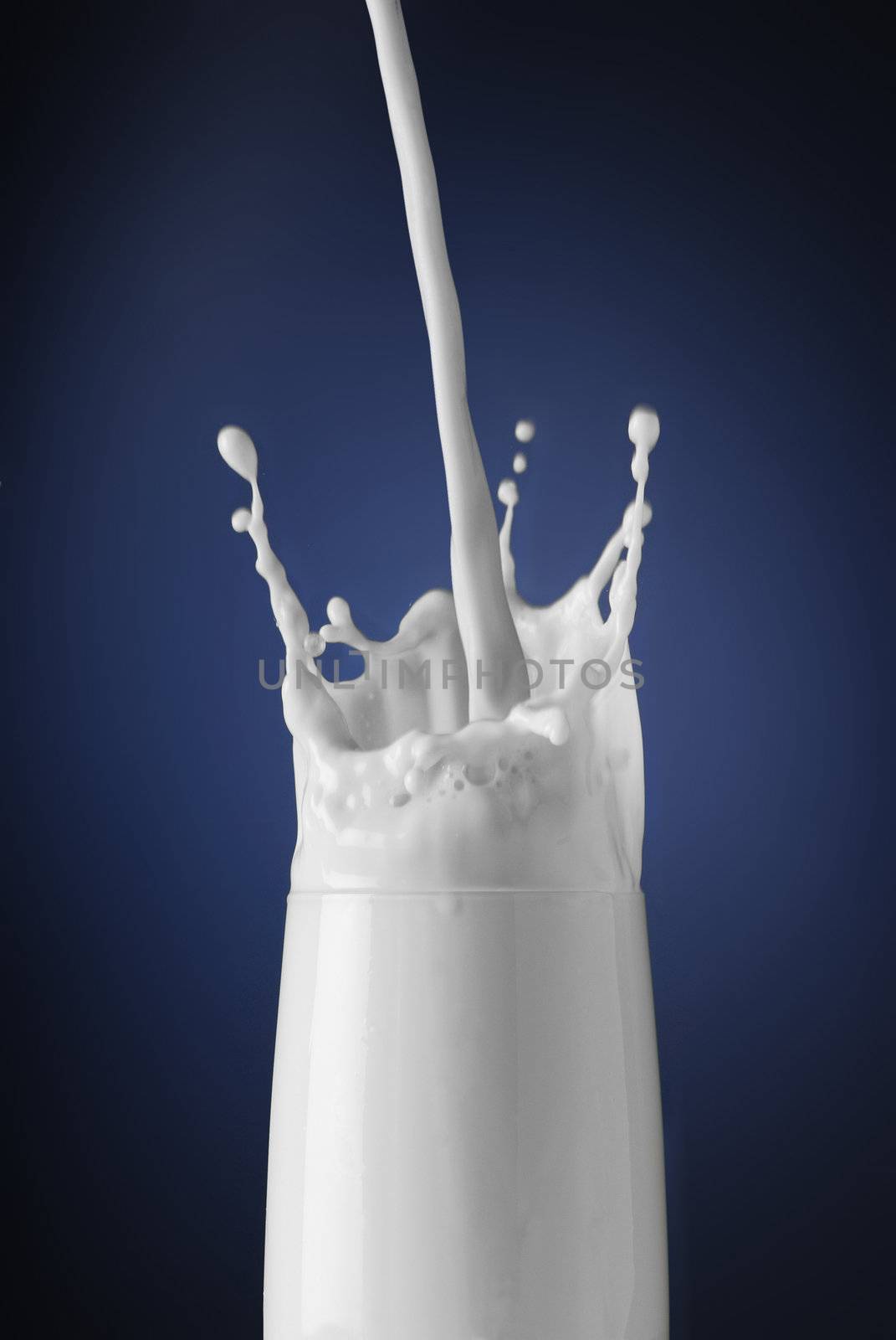 Morning start concept - milk splashing in a glass