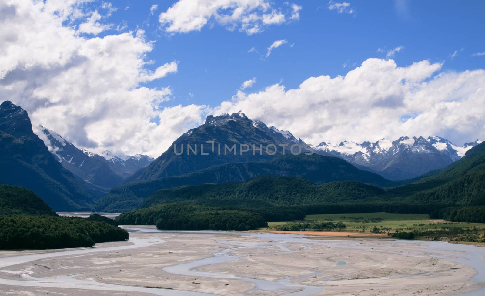 Rolling countryside valley in New Zealand with folded hills and mountains