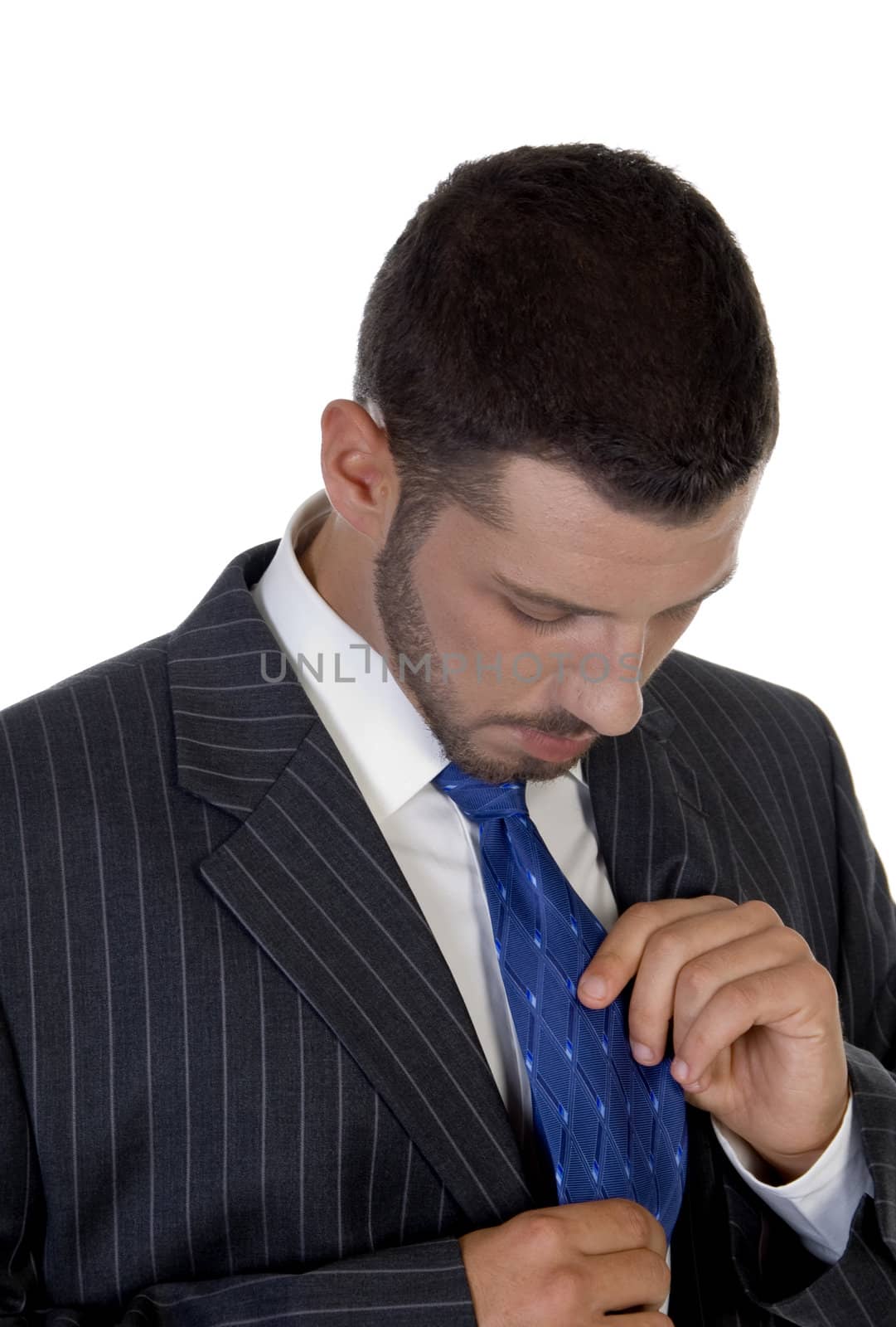 man looking his tie on an isolated white  background