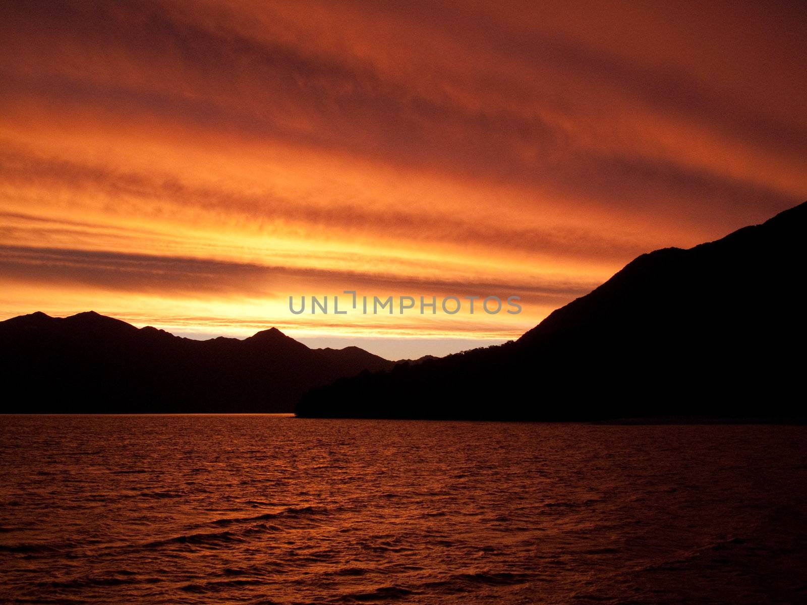 Brilliant sunset over the sea near Queenstown in New Zealand