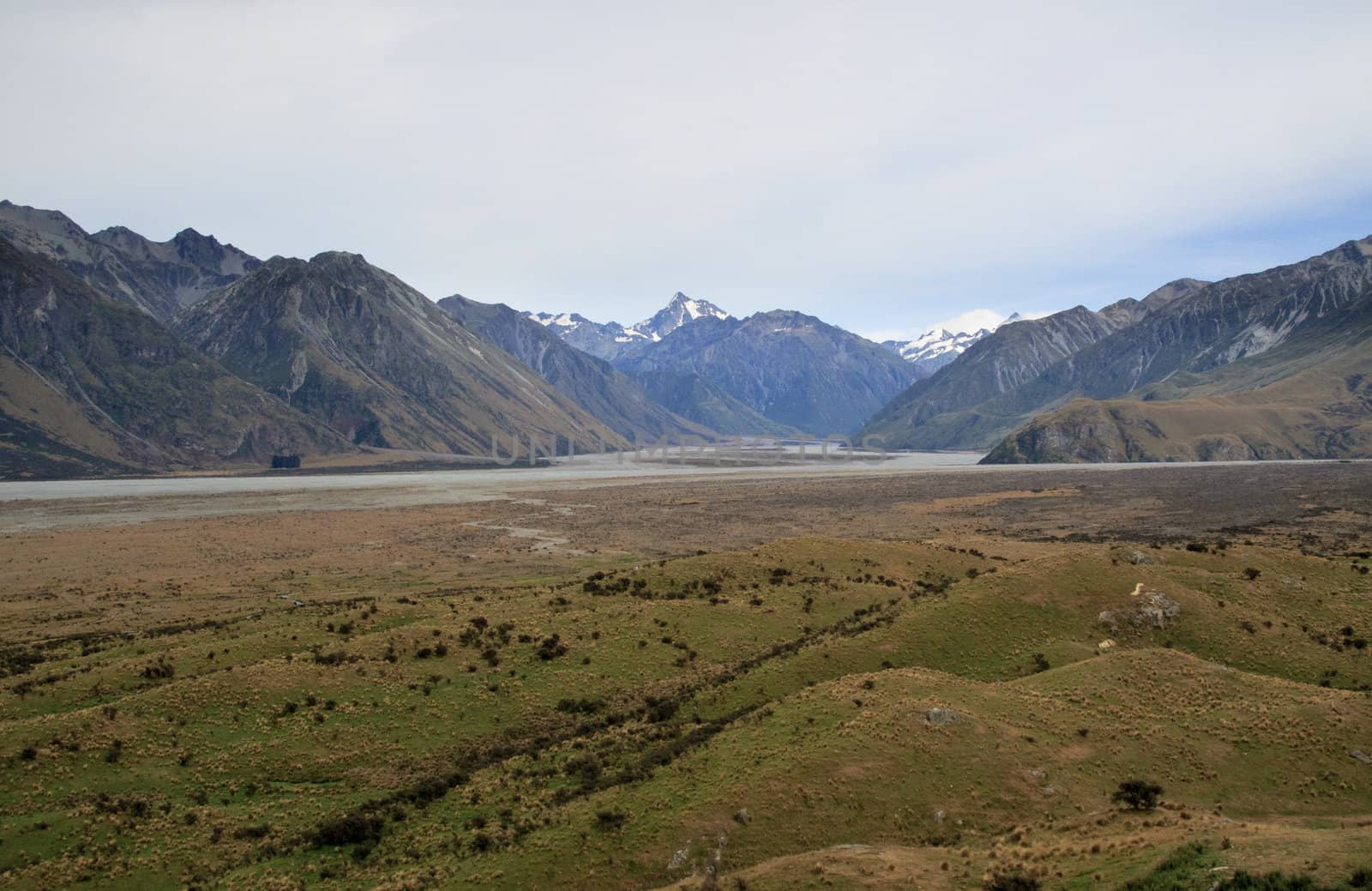 Mount Cook over a grassy plain by steheap