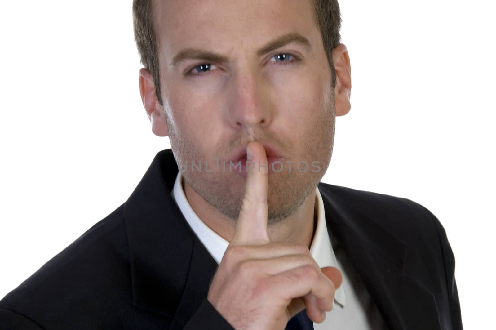 portrait of businessman with his finger on his lips on white background