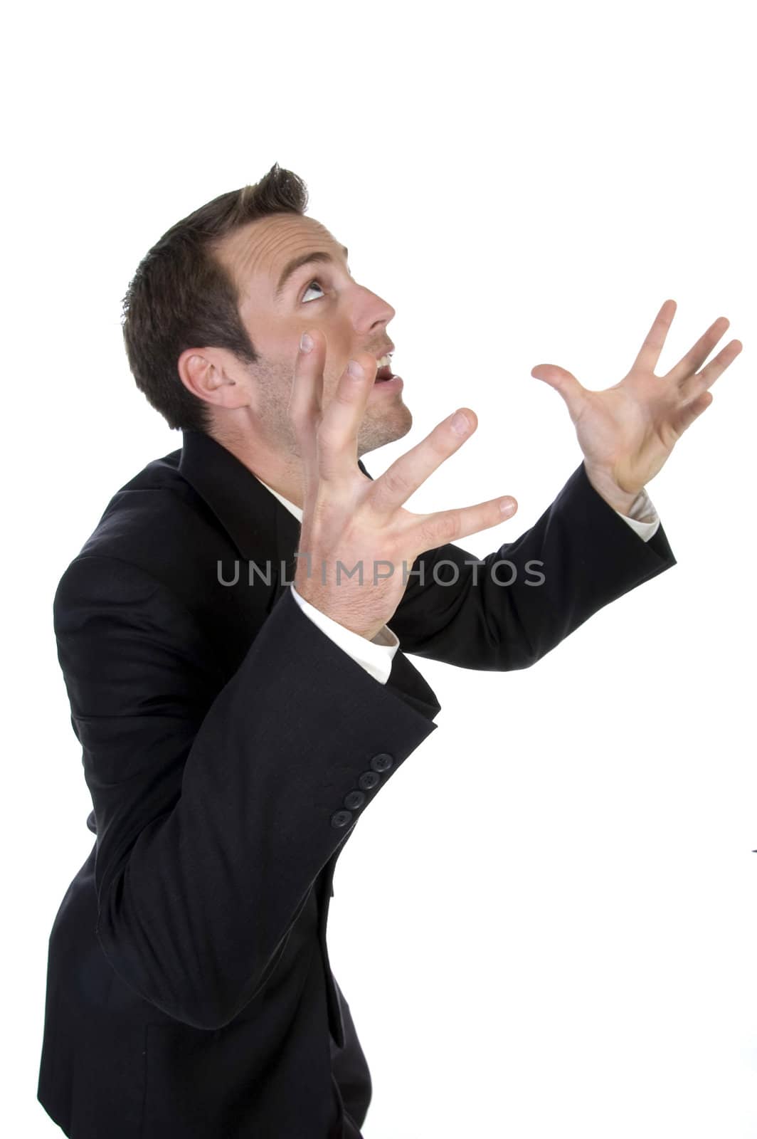 young businessman yelling with raised arms on white background