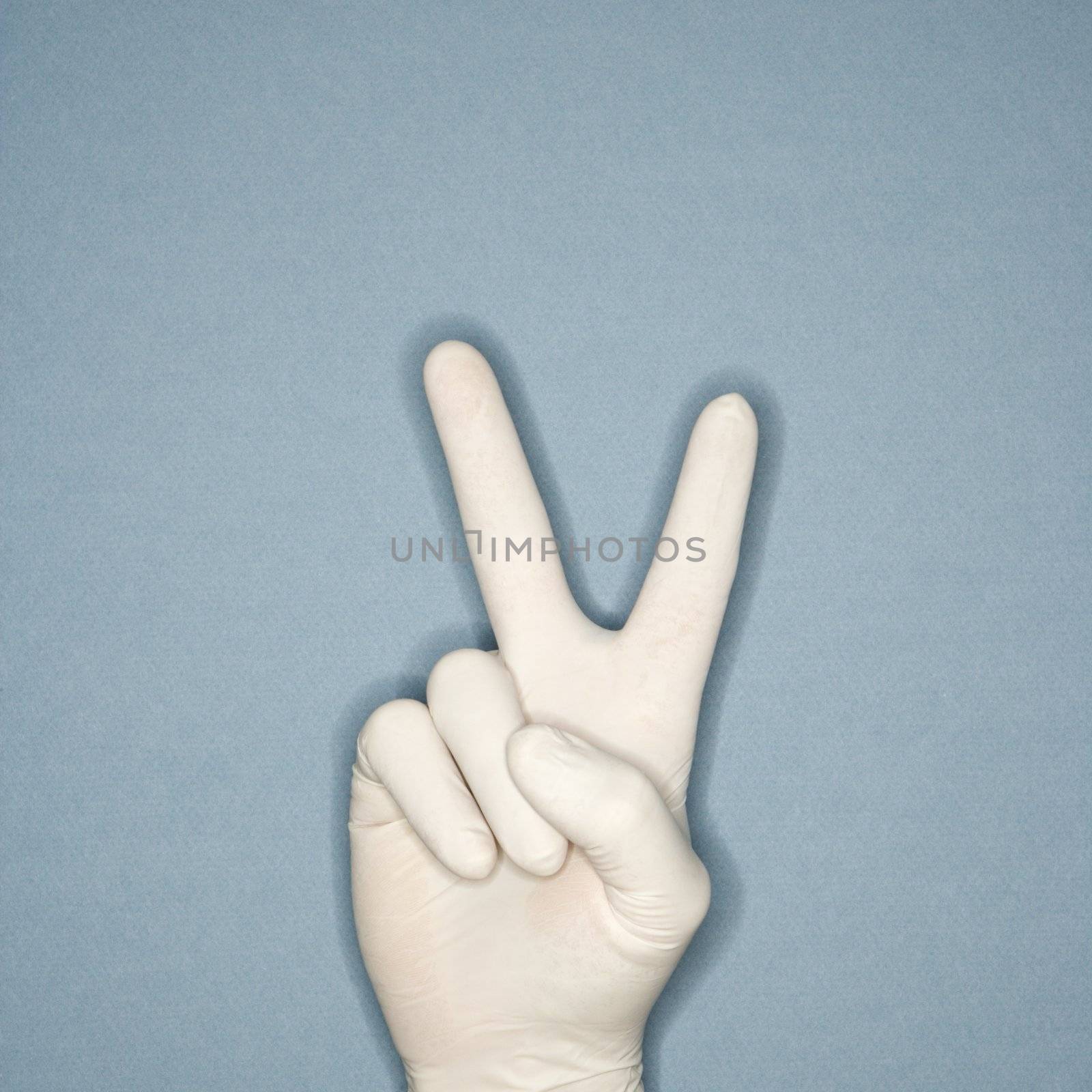 Hand giving peace sign. by iofoto