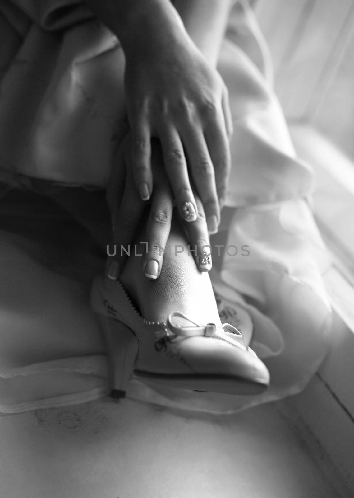 Wedding shoes on legs of the bride