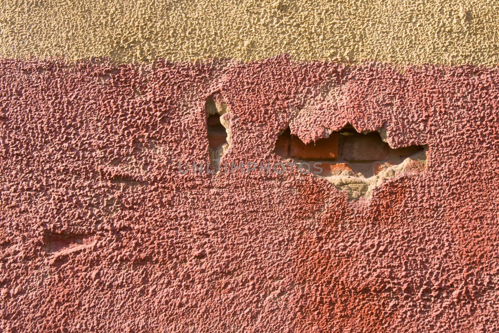 Yellow and red painted old brick wall 