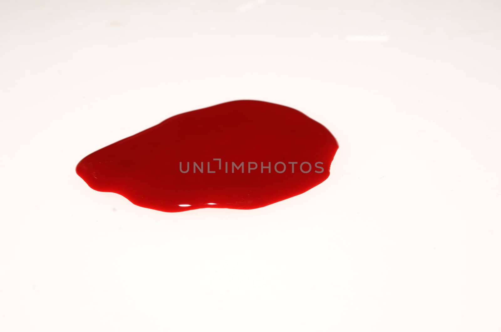 Puddle of red blood on white
