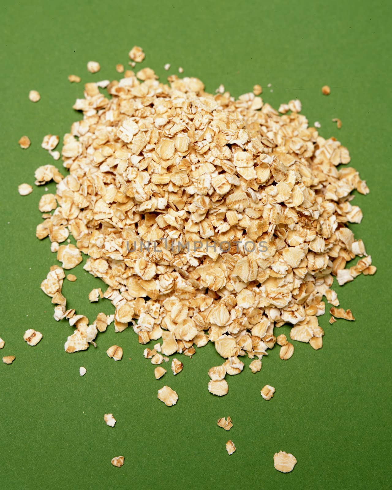 A small pile of rolled oats on green
