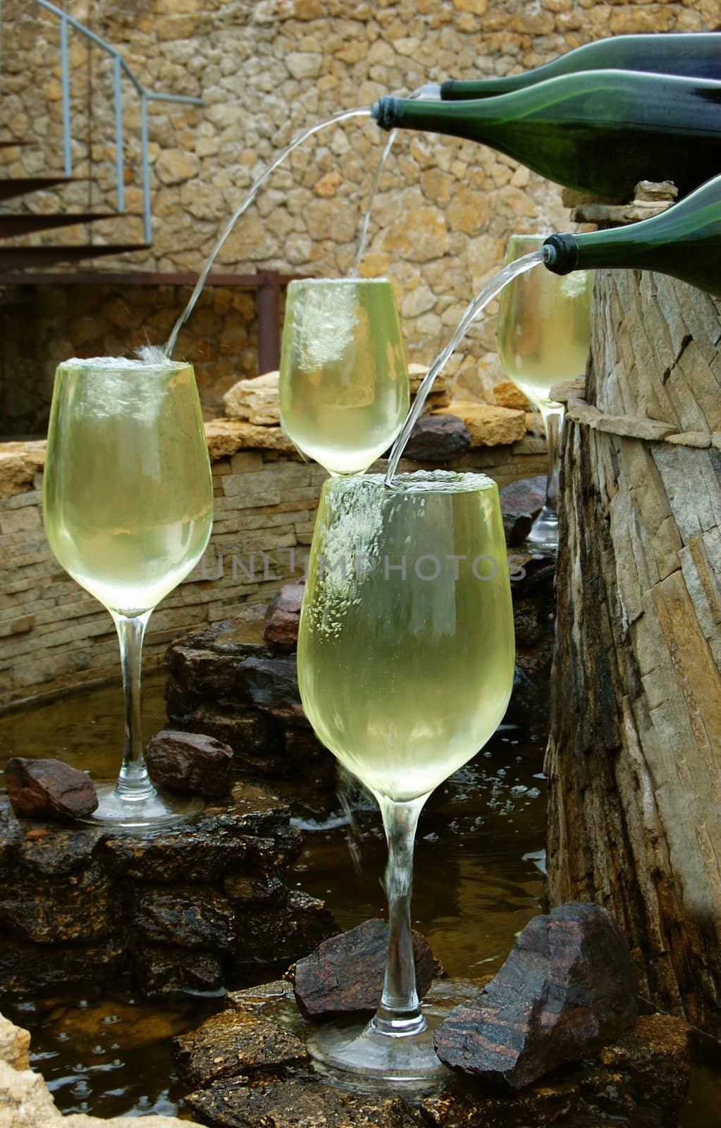 white wine fountain pouring in glasses