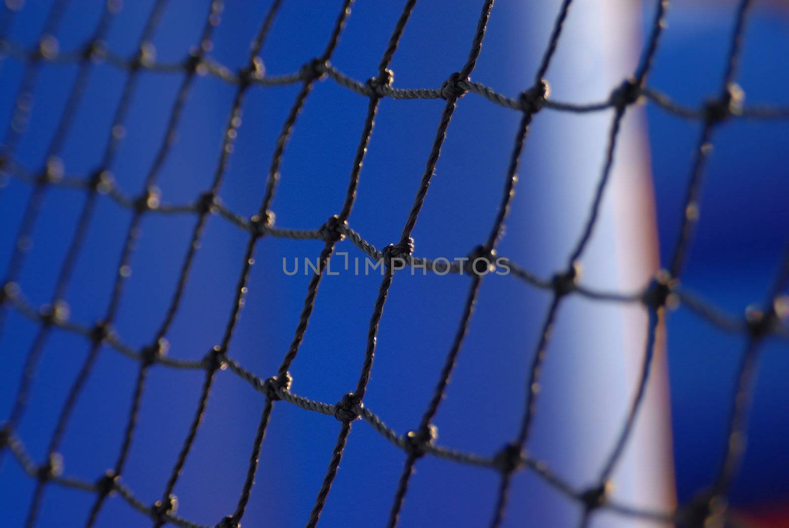 Partial view of a football arch net on sky background