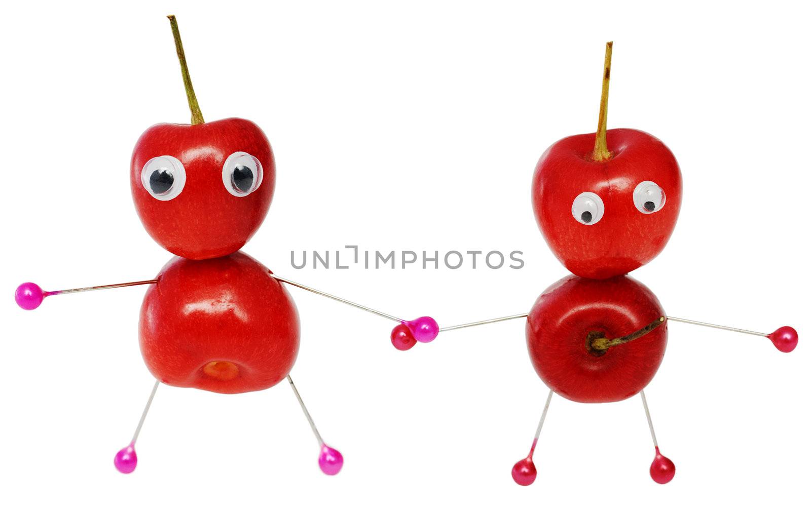 Two funny little men collected from a sweet cherry