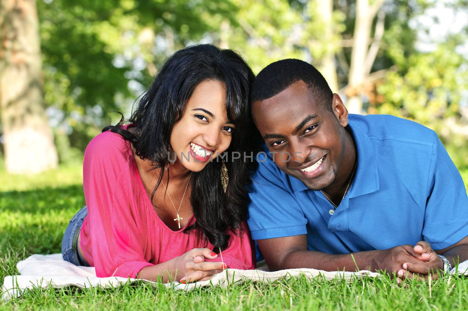 Young romantic couple enjoying summer day in park