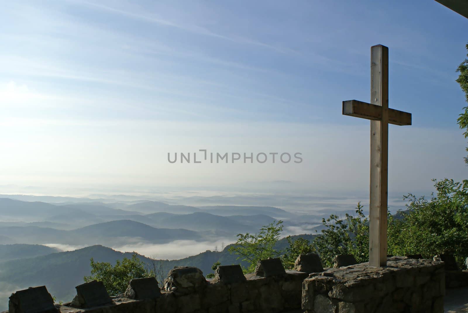 Cross overlooking the mountains in a church.         