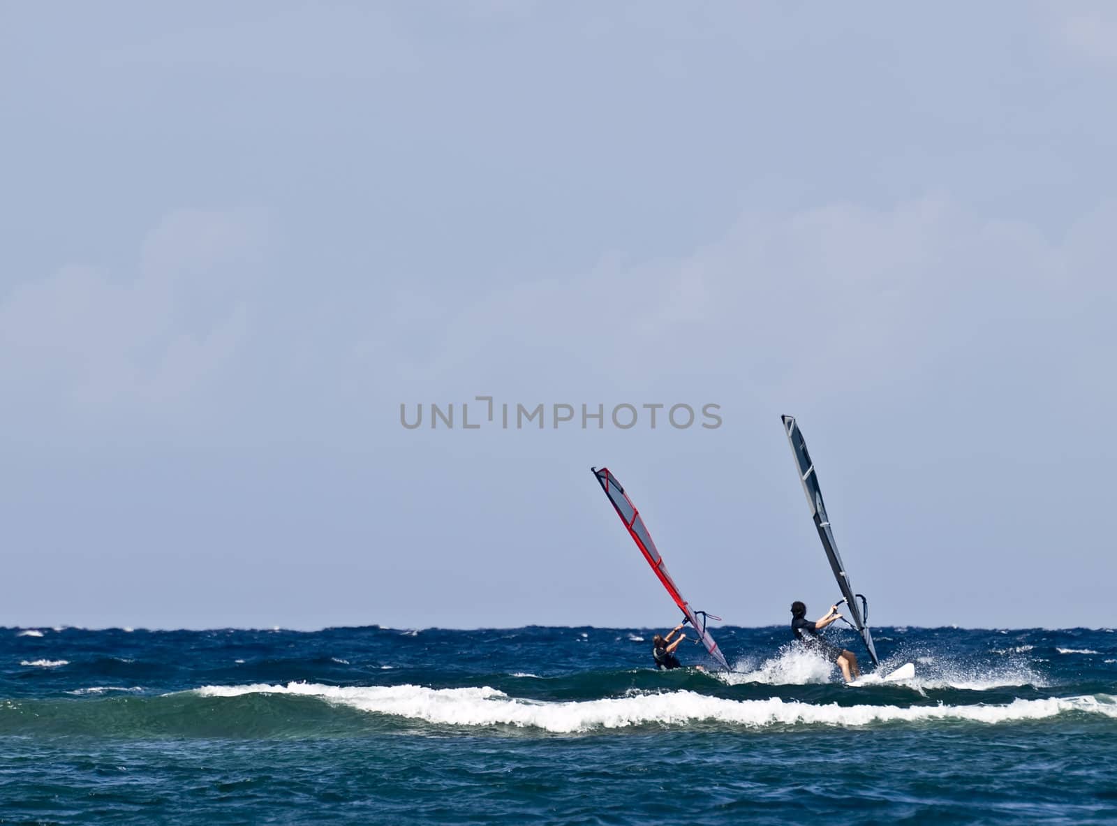 Two windsurfers having a race in the Mediterranean Sea