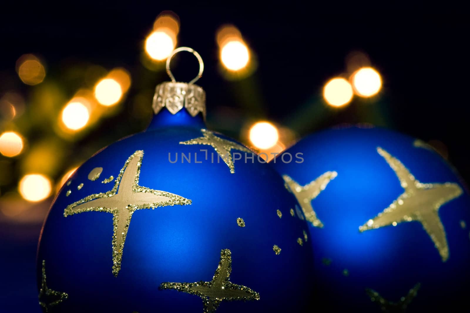 Christmas blue baubles with blurred lights in background, selective focus