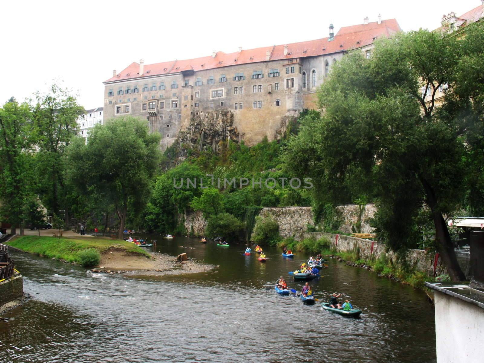 Mini rafting on river under walls of ancient castle