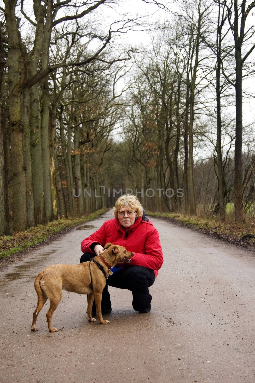 elderly woman together with the dog in a park by ladyminnie