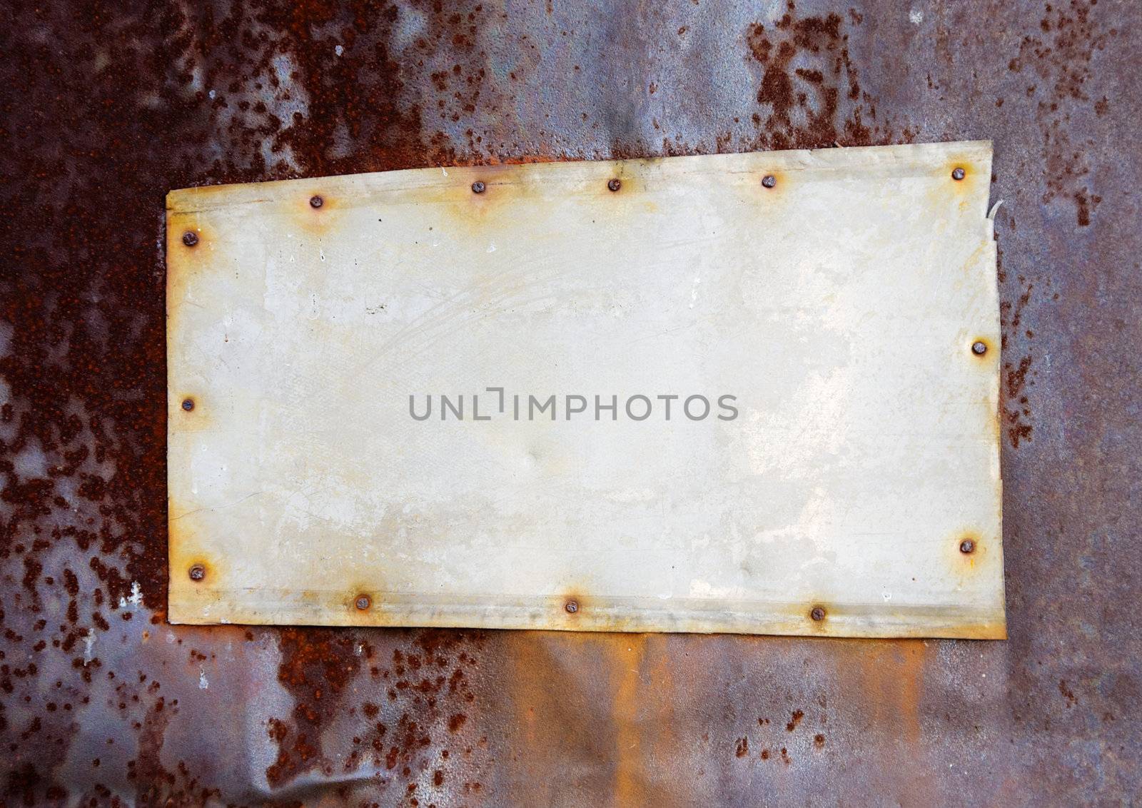 The old metal tablet on a rusty wall