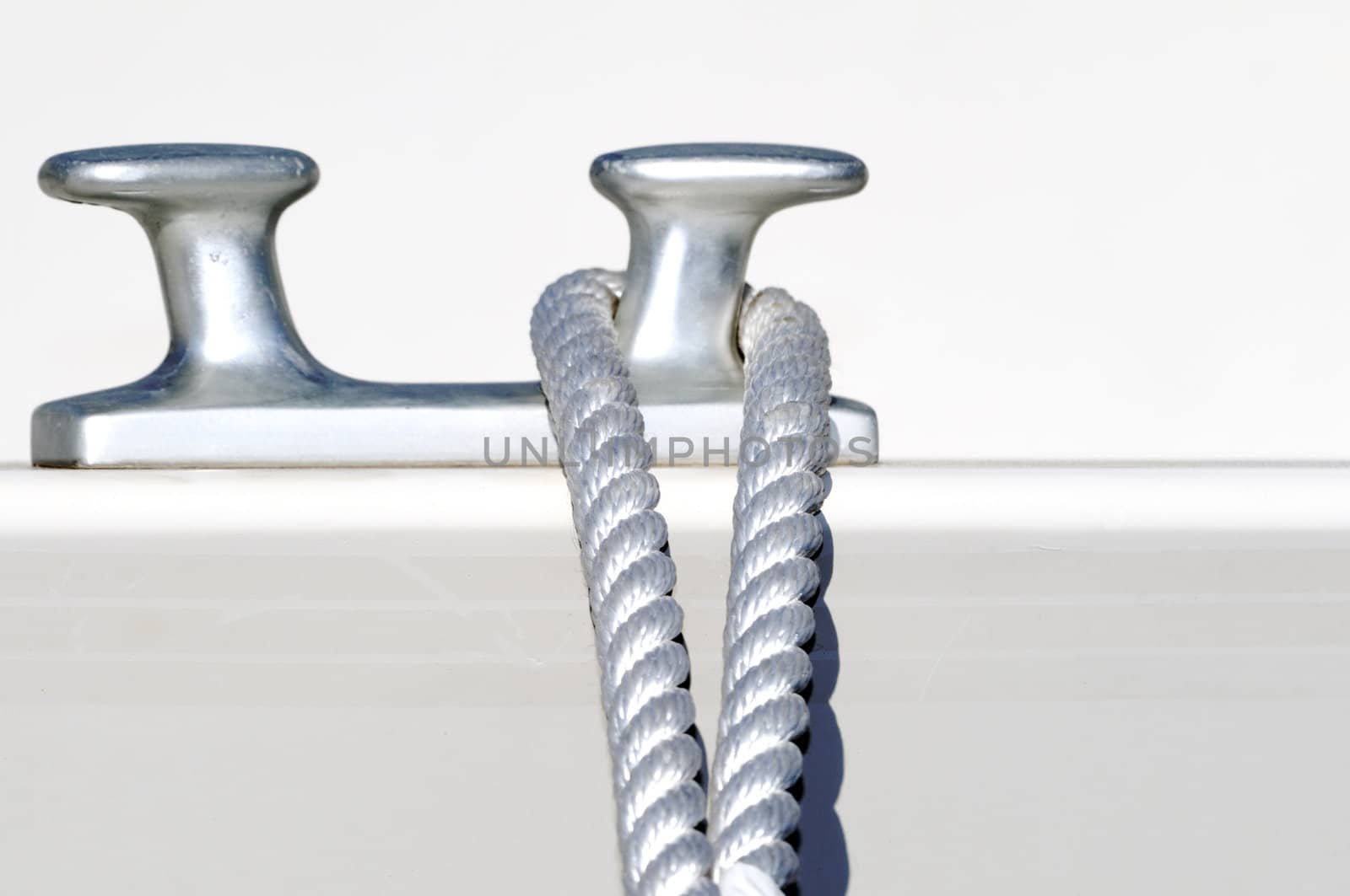 Detail of a rope securing a white boat