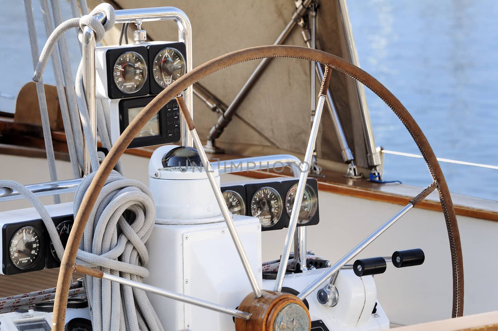 detail of steering wheel and navigation instruments of a sailboat