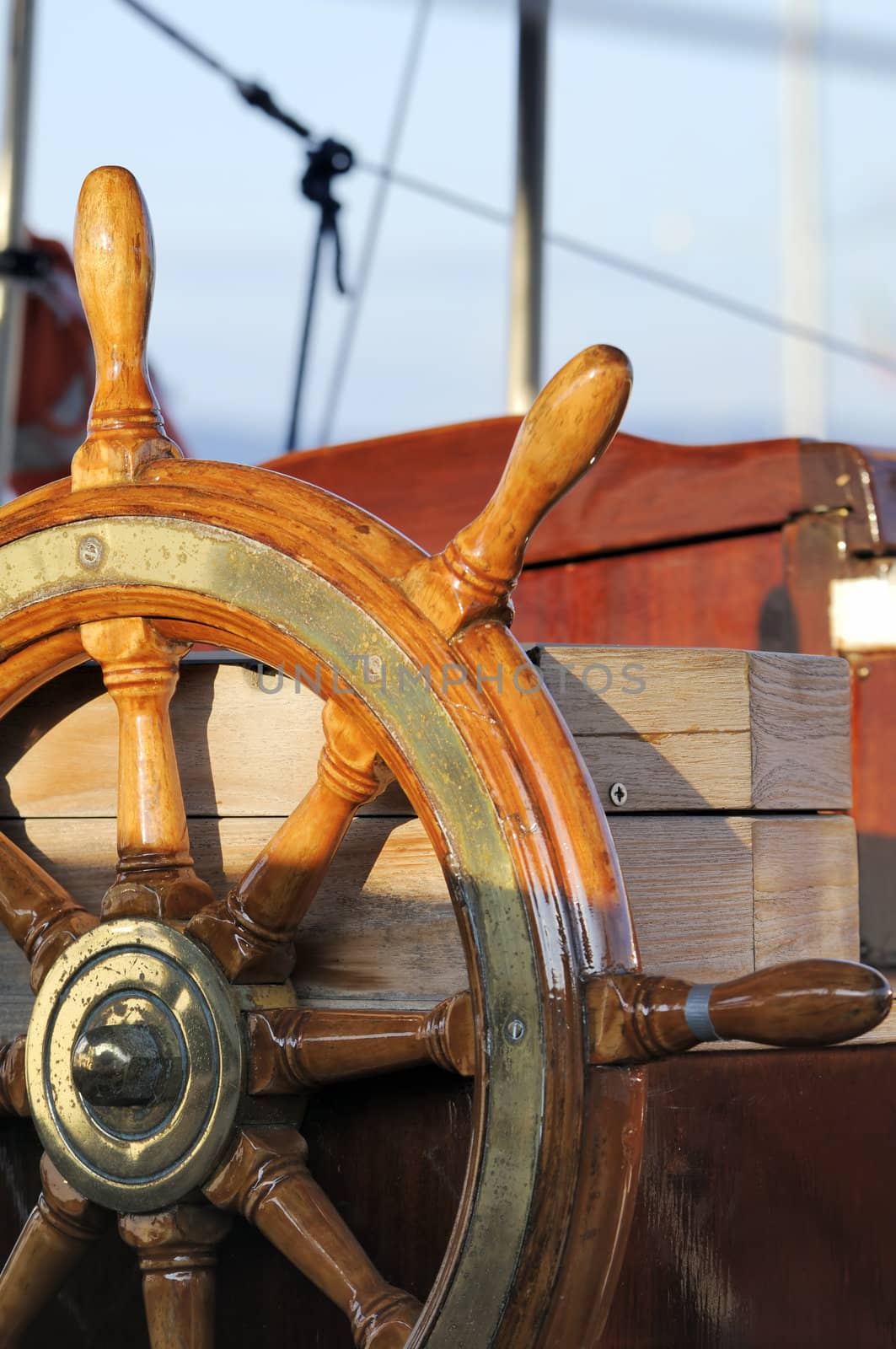 Detail of a wooden steering wheel on a vintage sailboat