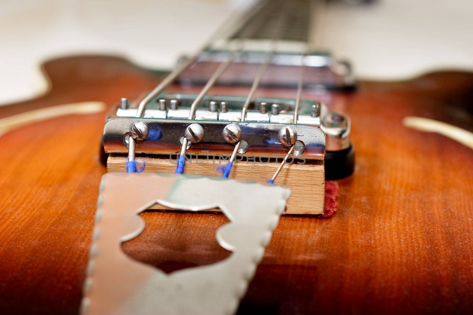 Old bass guitar close-up, shallow depth of field
