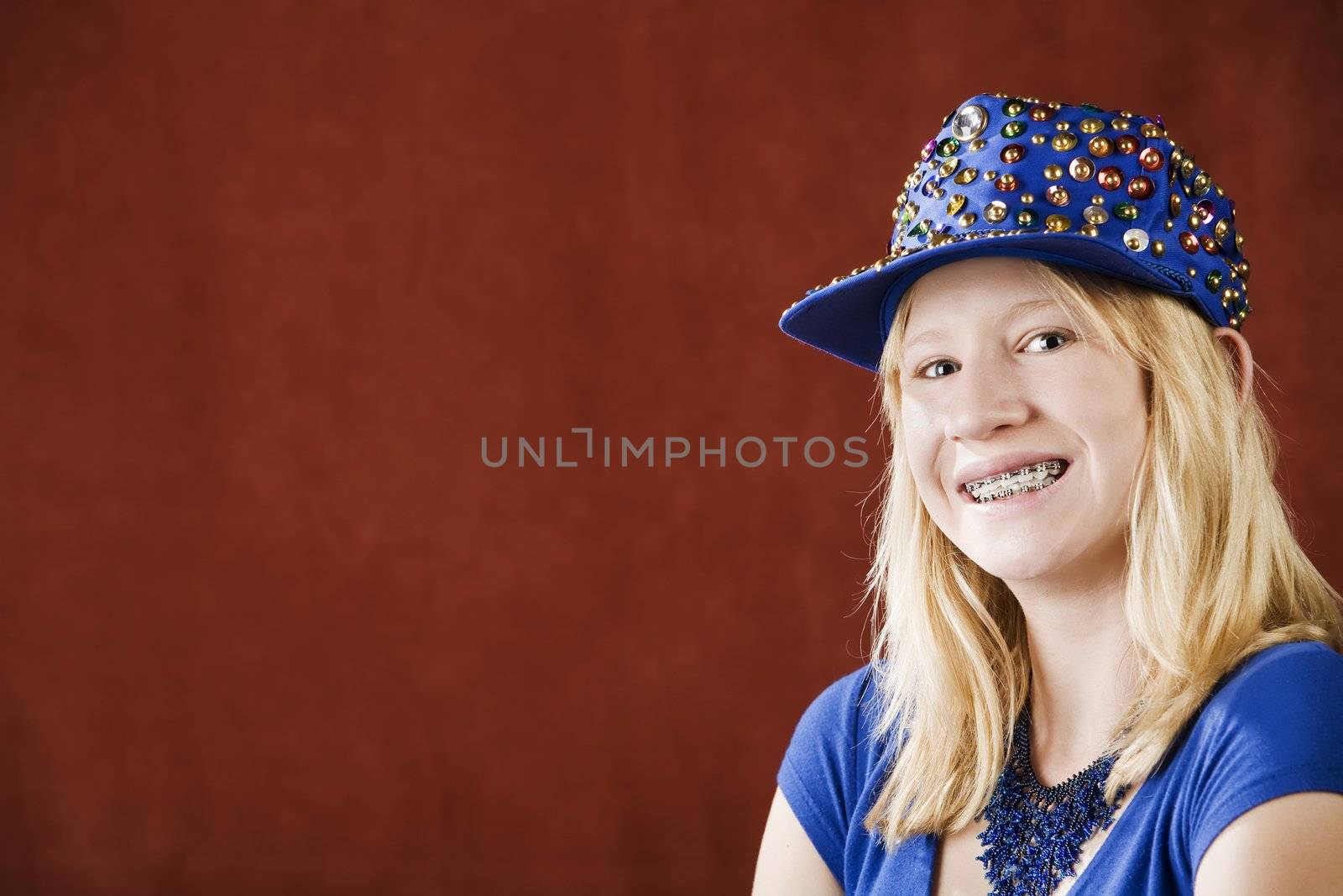 Teenage girl with braces wearing a hat with sequins