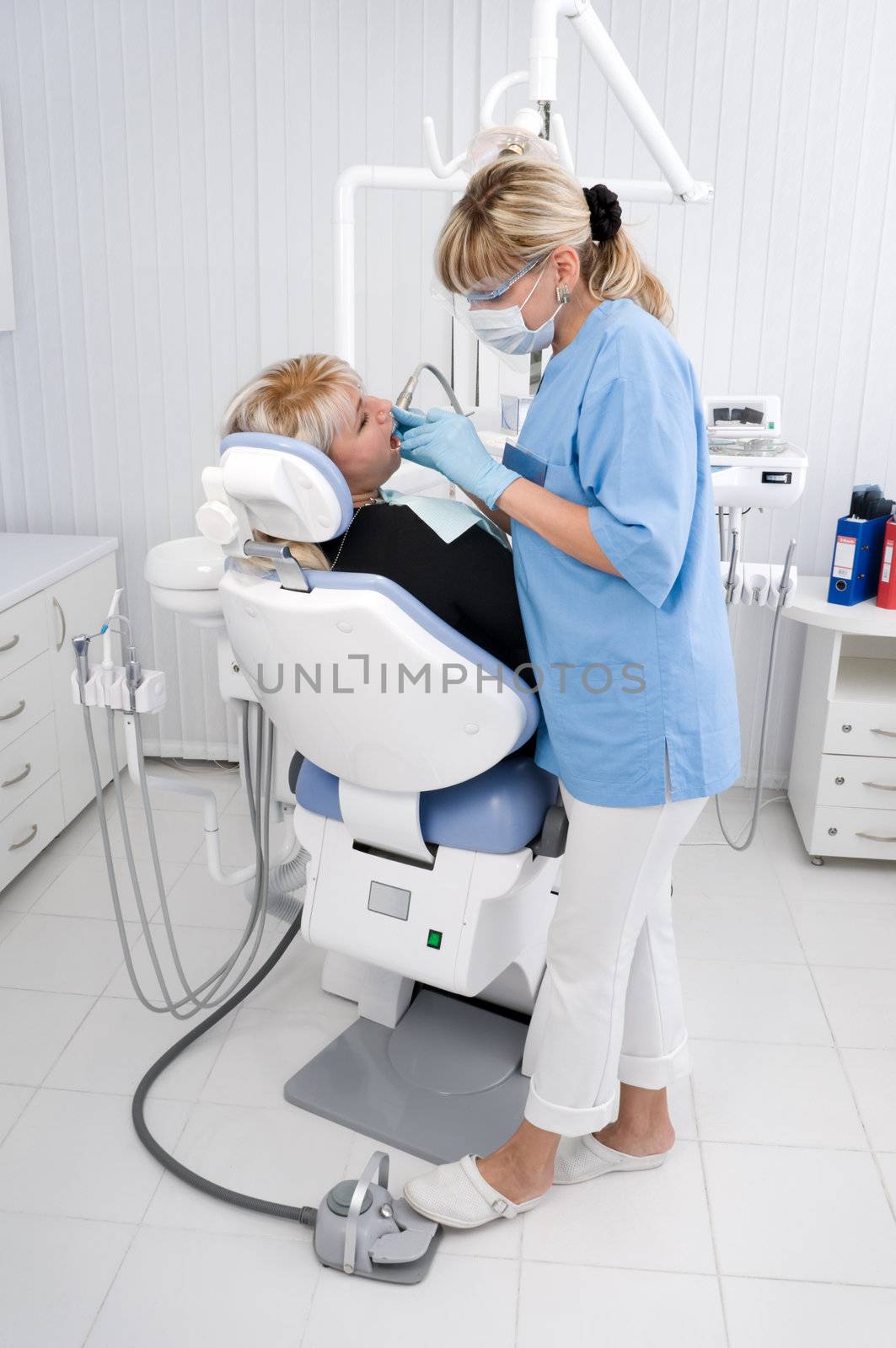 doctor works with patient in the dentist office