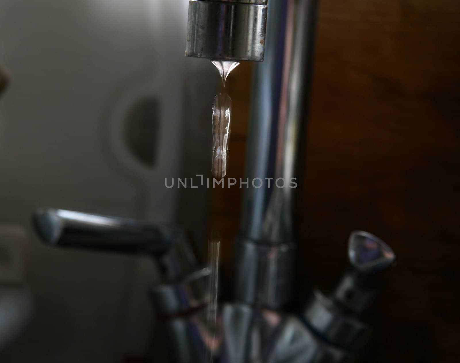 water flowing from a tap focus of the waterdrops