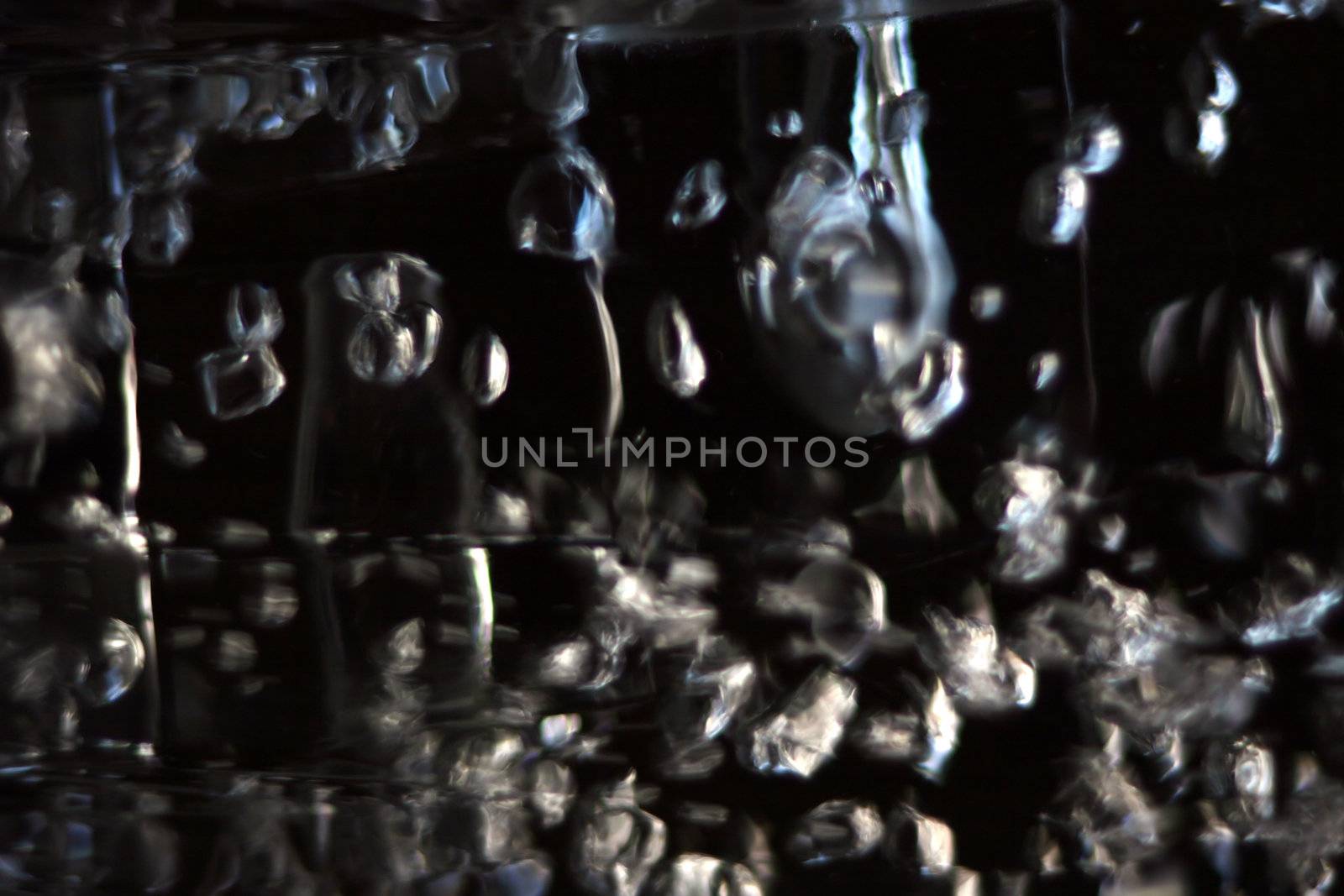 abstract bubbles reflecting light against a dark background
