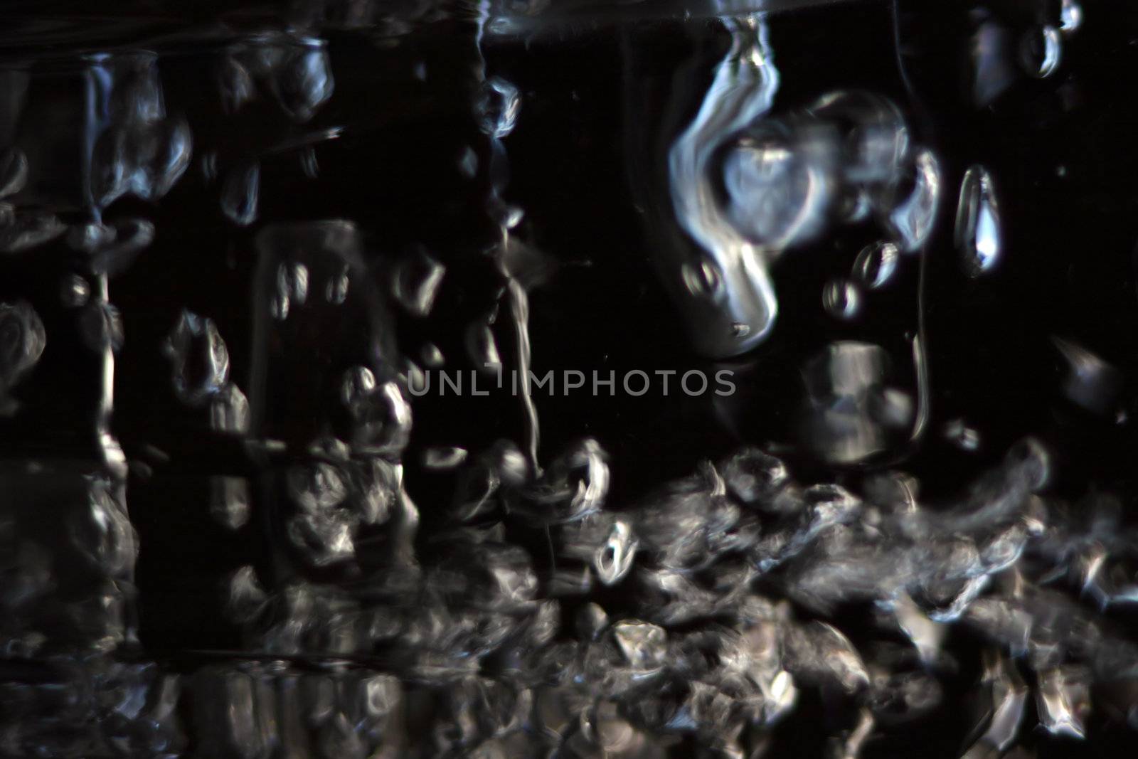 abstract bubbles reflecting light against a dark background