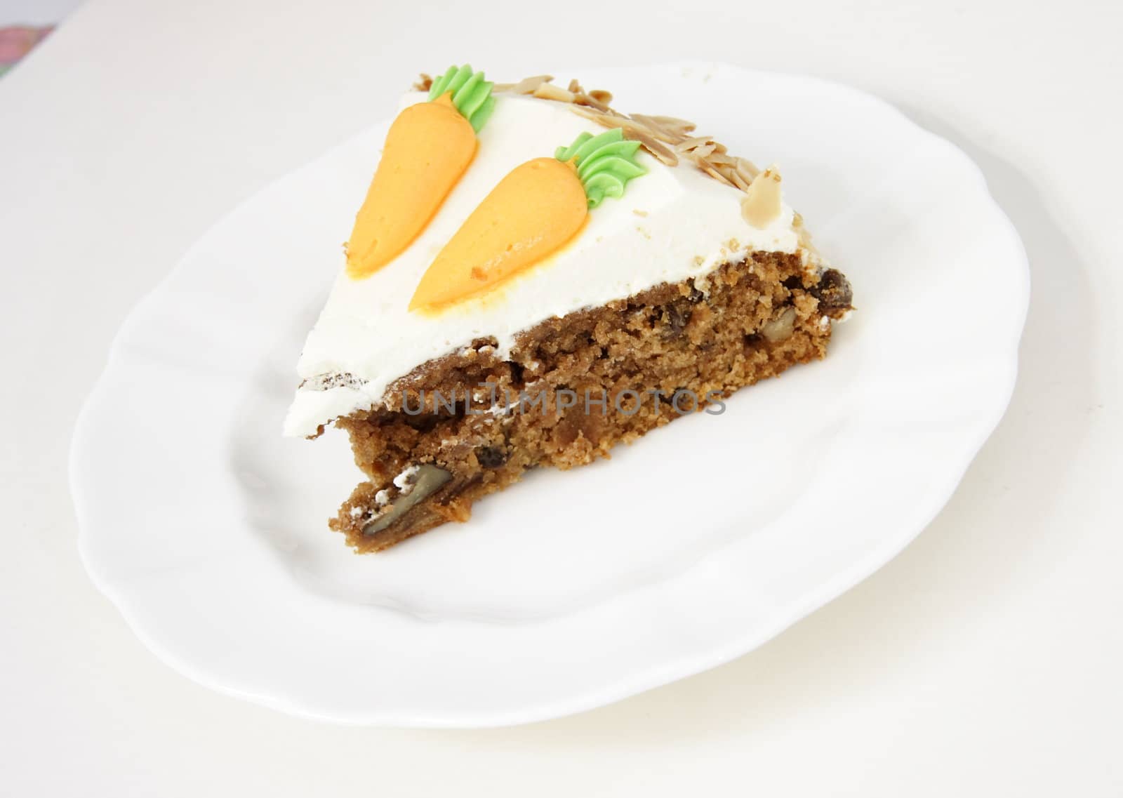 single serving of carrot cake on a white plate