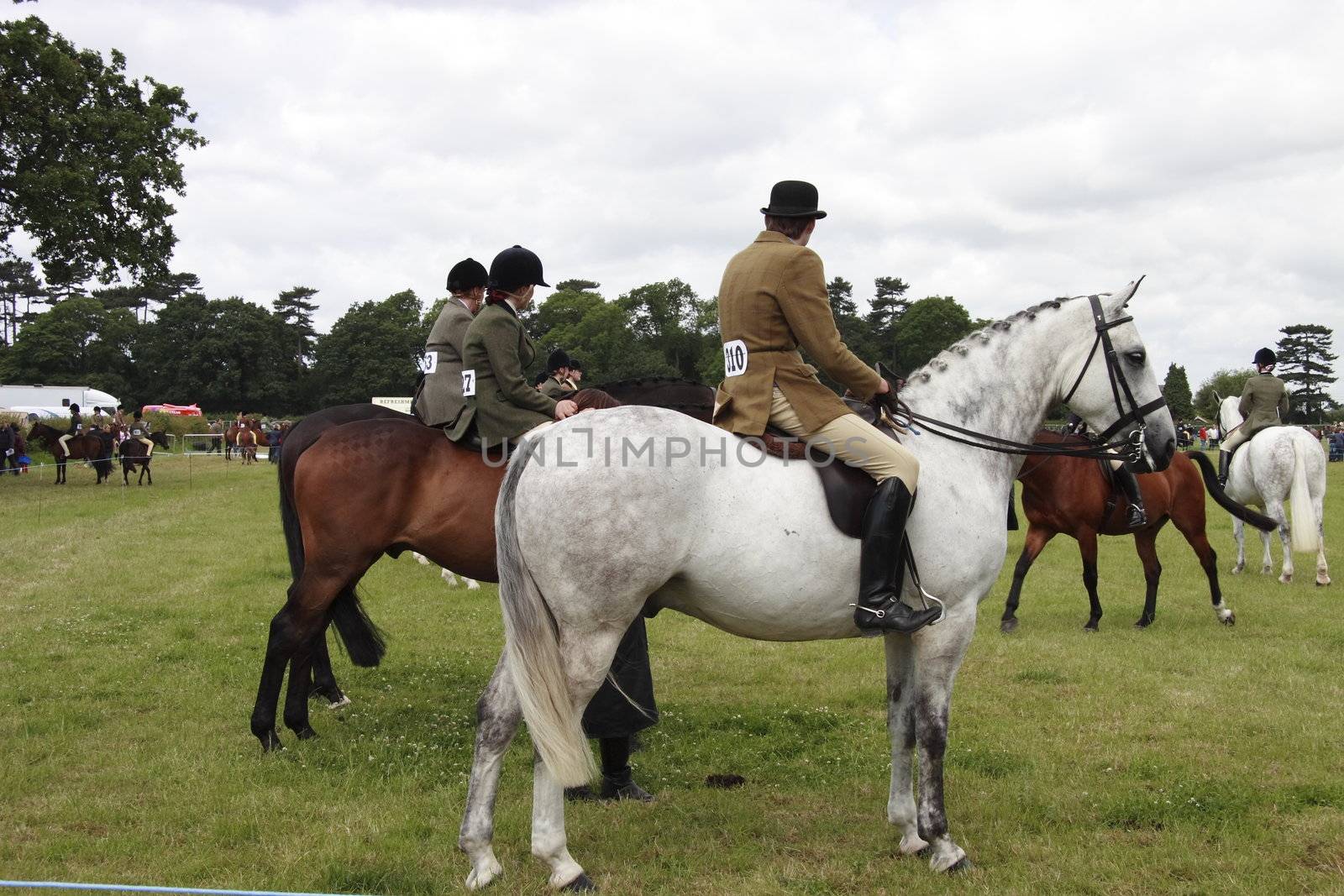 horses and riders waiting to perform at the county show