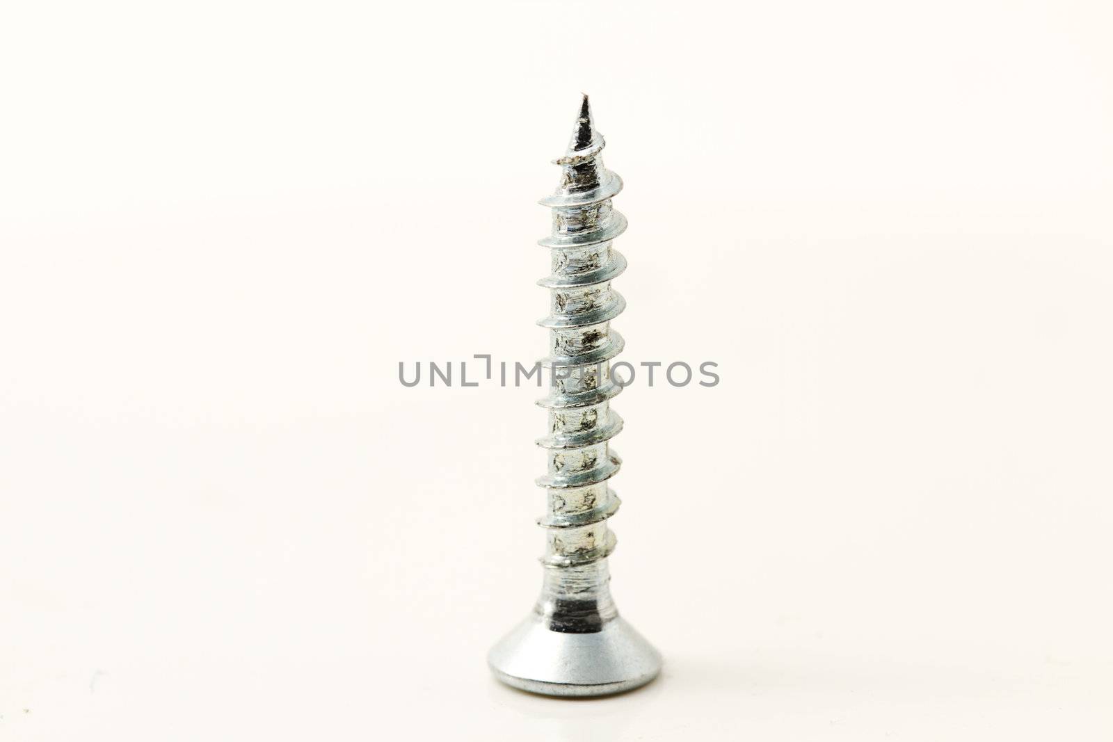 one small screw isolated on white background