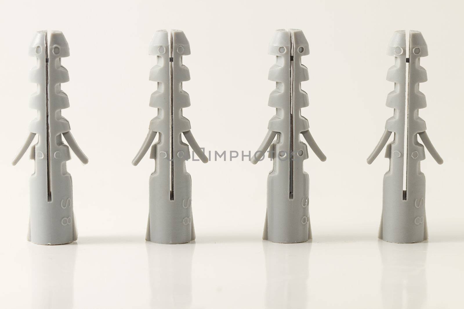 four standing rawlplugs on white background