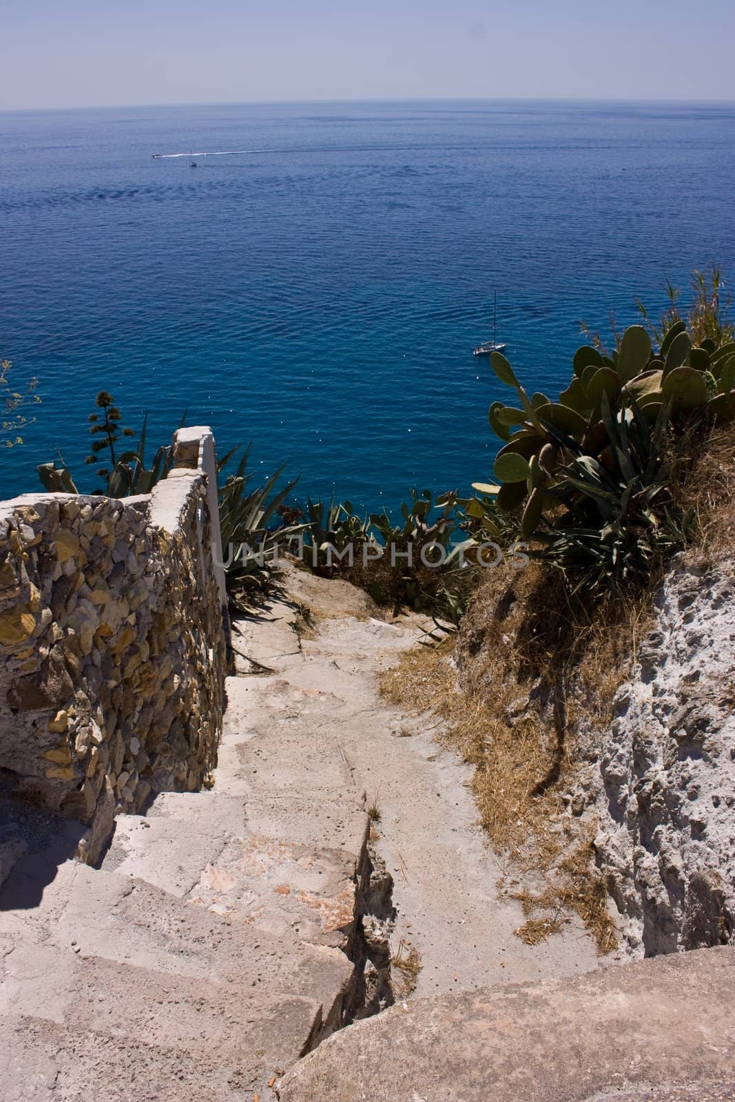 Stoned stairs leading down  to the blue sea. Ponza island, Italy