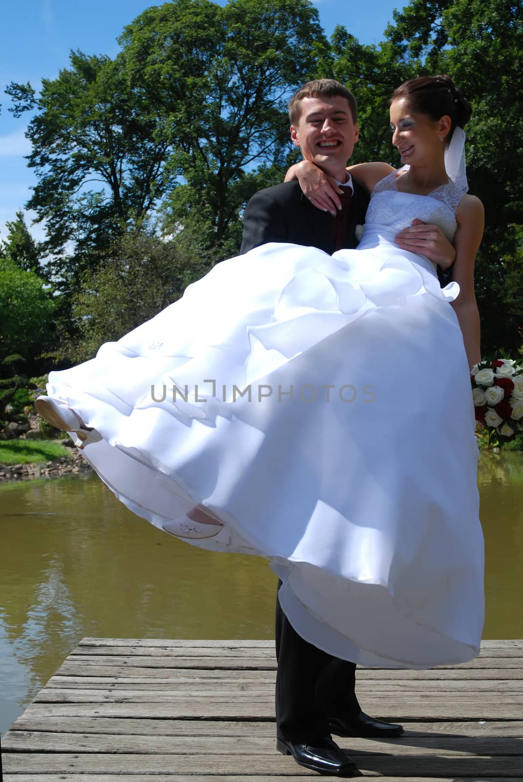 Young wedding couple just married over green nature