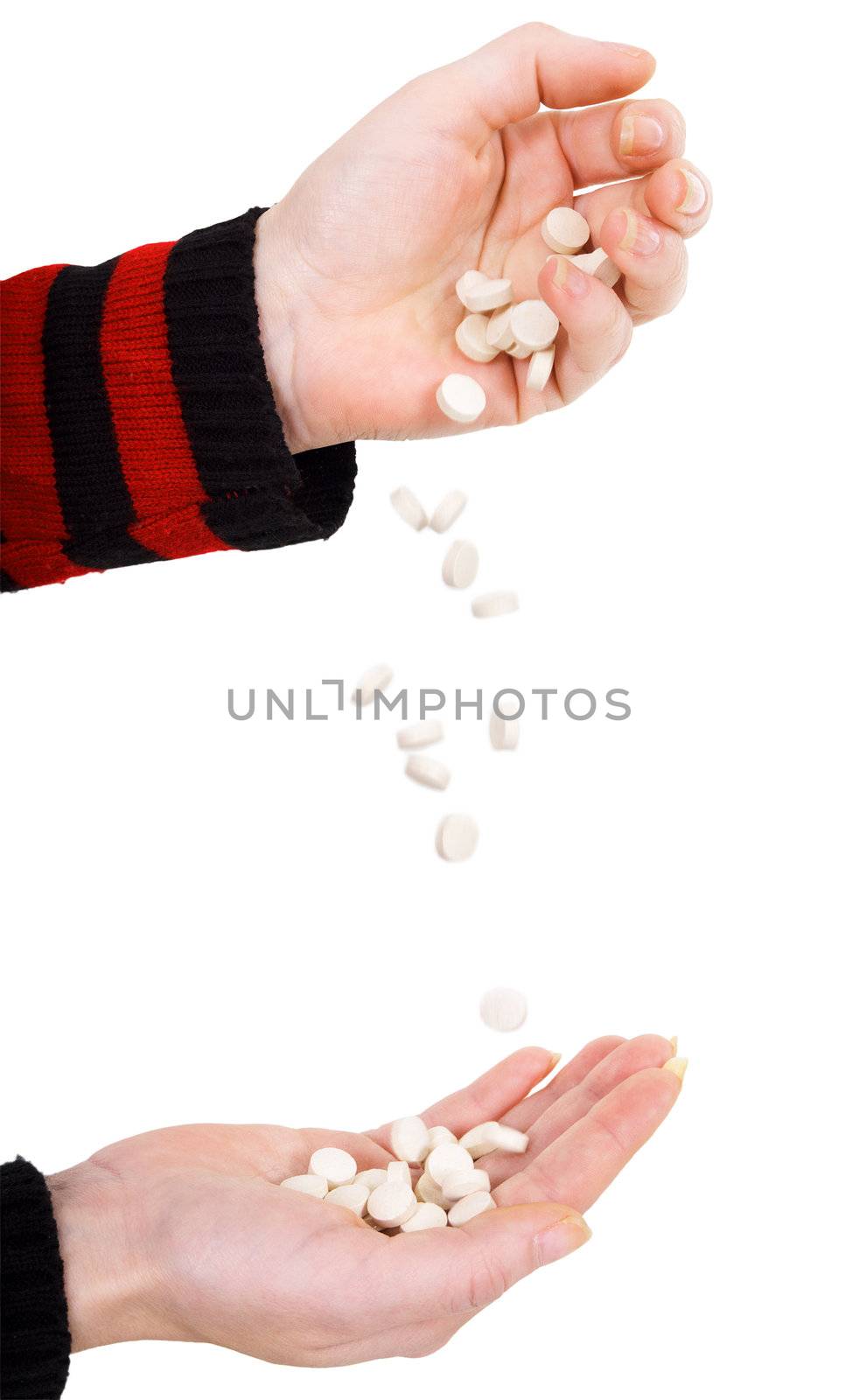 Tablets falling from one hand on other hand