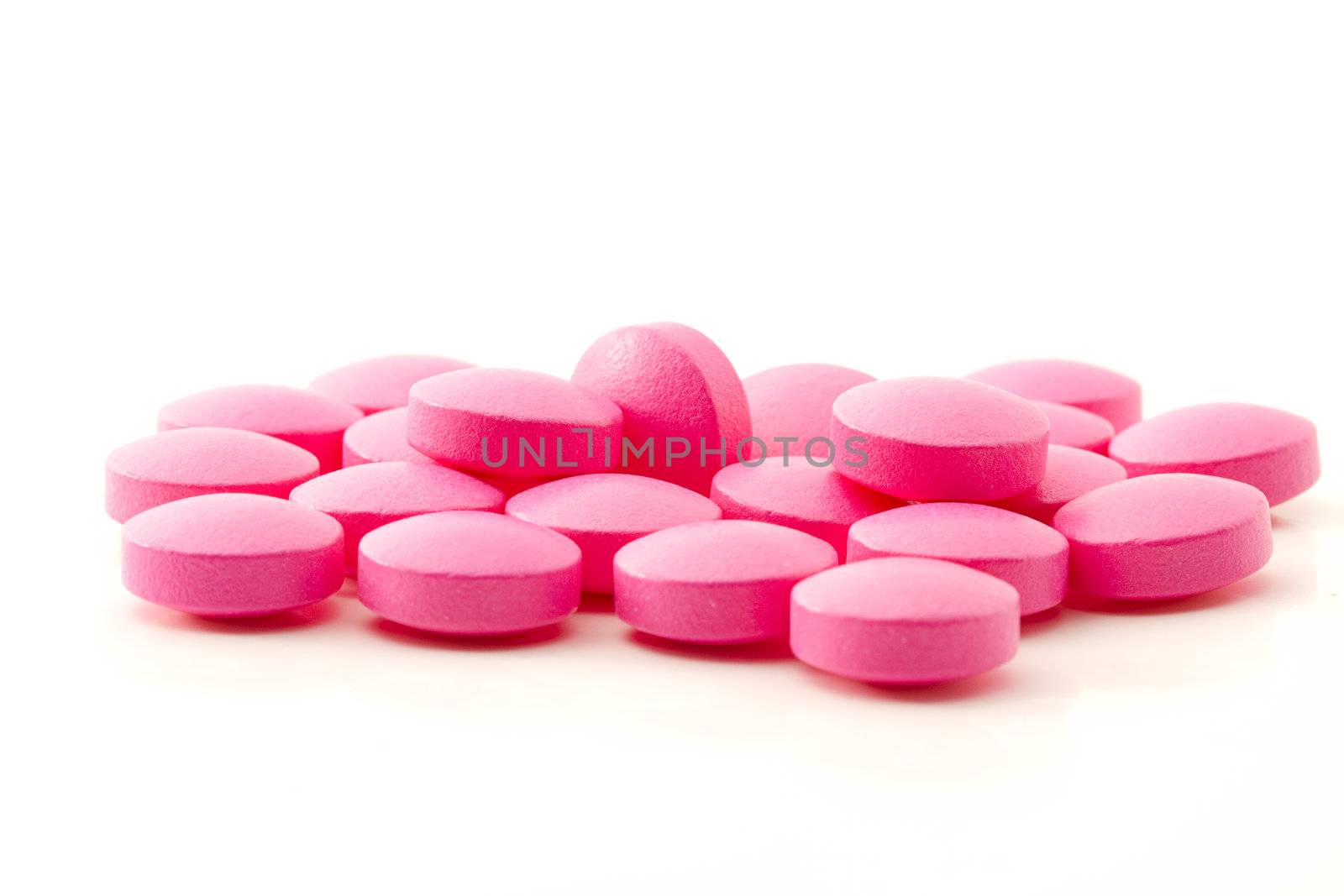 some pink painkiller pills on white background
