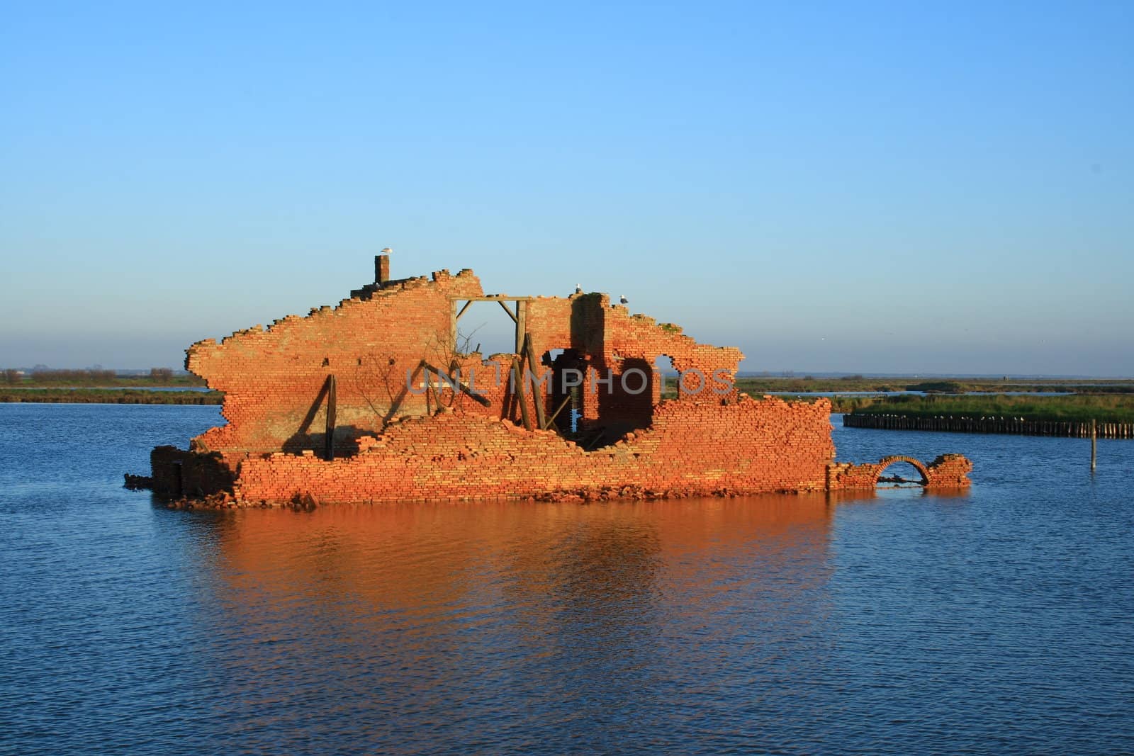 ancient house in comacchio (italy) in the middle of a lake.