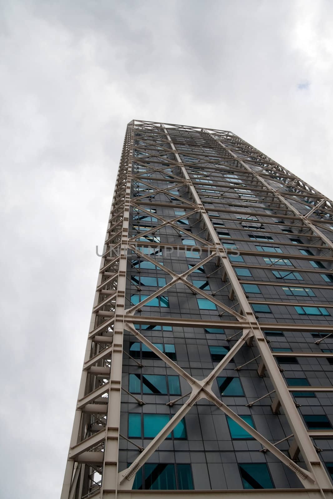 Modern sky scraper rising into the sky on a cloudy day